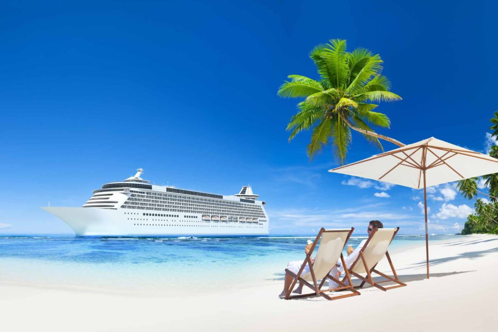 Image of sandy beach with cruise ship in distance